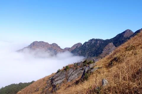 Clouds around the top of high mountain Stock Photos