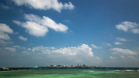 Clouds, azure ocean water and a modern city on a tropical island Stock Footage 196634313