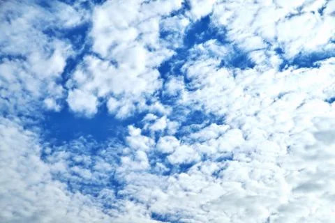 Clouds on the background of bright blue sky, summer day close-up Stock Photos