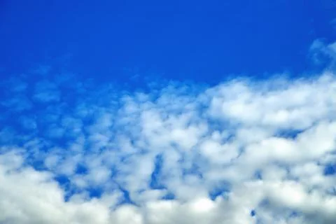 Clouds on the background of bright blue sky, summer day close-up Stock Photos