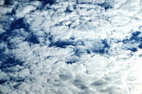 Clouds on the background of bright blue sky, summer day close-up Stock Photos