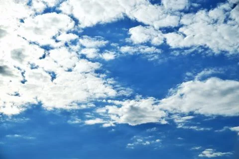 Clouds on the background of bright blue sky, summer day close-up Stock Photos