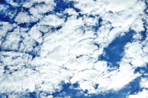 Clouds on the background of bright blue sky, summer day close-up Stock Photos