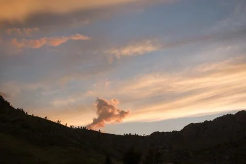 Clouds in the background silhouette of the mountains at sunset Stock Photos