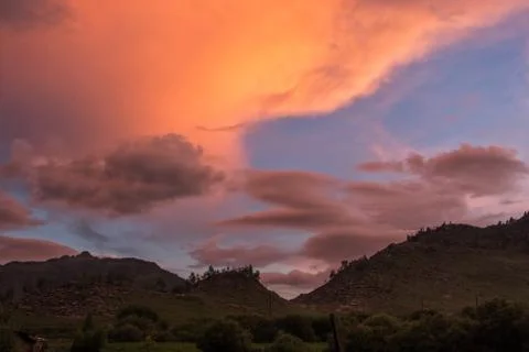 Clouds in the background silhouette of the mountains at sunset Stock Photos
