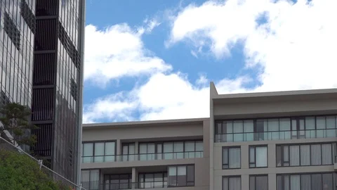 Clouds on the background of a tall mirror building Stock Footage 121651632