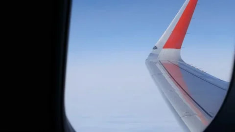 The clouds behind the illuminator, the blue sky and the edge of the wing are Stock Footage 165147301