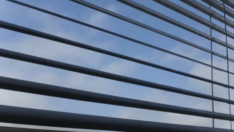 Clouds from Behind Window Shutters Stock Footage 121224489
