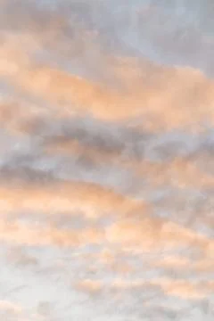 Clouds being coloured by the sunset Stock Photos