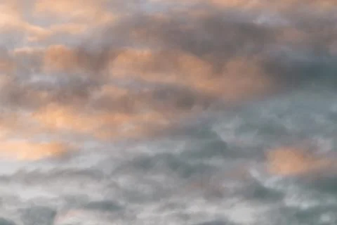 Clouds being coloured by the sunset Stock Photos