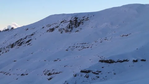Clouds between snowy mountains Stock Footage 77051770