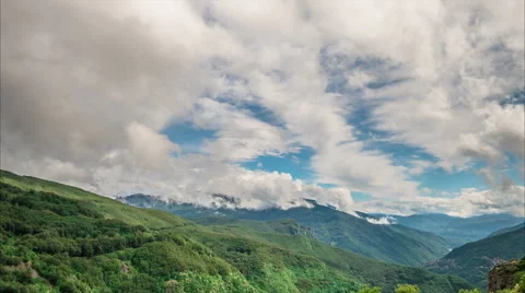 Clouds billow in the blue sky over mountains Video stock 50897084