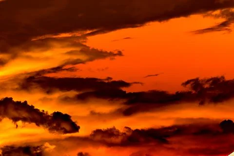Clouds billowing in the evening illuminated by the setting sun Stock Photos