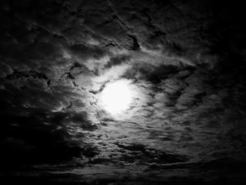 Clouds on black background. black sky with clouds and sun. Stock Photos