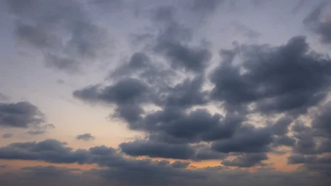 The clouds of black rain move slowly in the sun near the ground. Видео 104484908