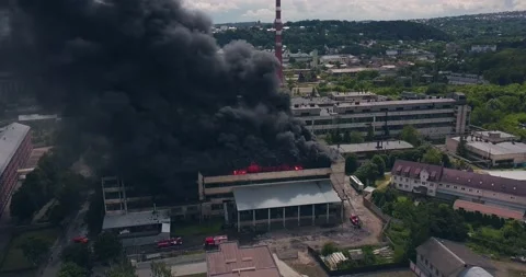 Clouds of Black Thick Smoke and Bright Flames Rising into the Air from the Stock-Footage 135407083