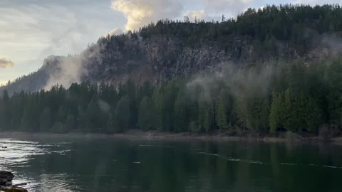 The clouds blends with the trees along the Clark Fork River at sunset in Montana Stock Footage 146145086