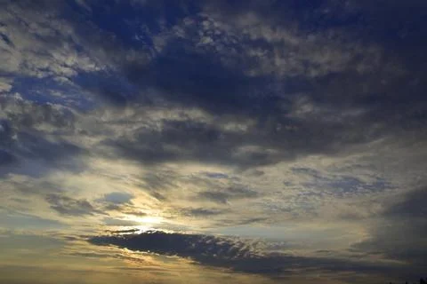 Clouds block the sun at sunset. Signs of worsening weather. Stock Photos
