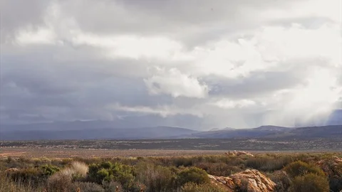 Clouds blowing down from the Cedarberg over flat open plains Stock Footage 114742208