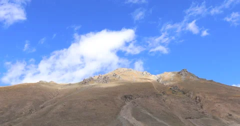 Clouds blowing over high altitude mountains on tibet, China Stock Footage 144423776