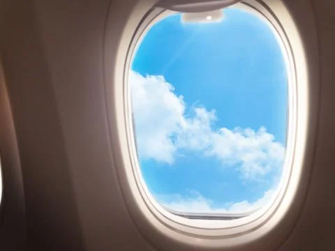 Clouds on a blue background in the porthole window Stock Photos
