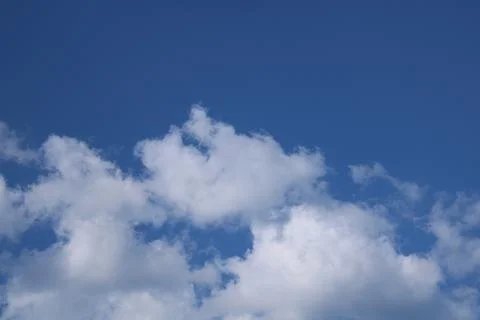 Clouds on a blue background with white clouds. Stock Photos