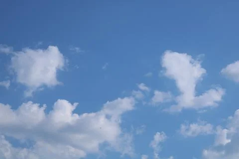 Clouds on a blue background with white clouds. Stock Photos
