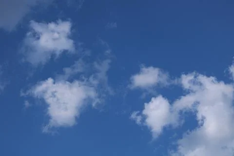Clouds on a blue background with white clouds. Stock Photos