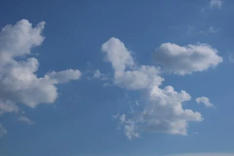 Clouds on a blue background with white clouds. Stock Photos