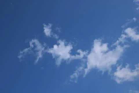 Clouds on a blue background with white clouds. Stock Photos