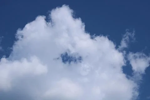 Clouds on a blue background with white clouds. Stock Photos