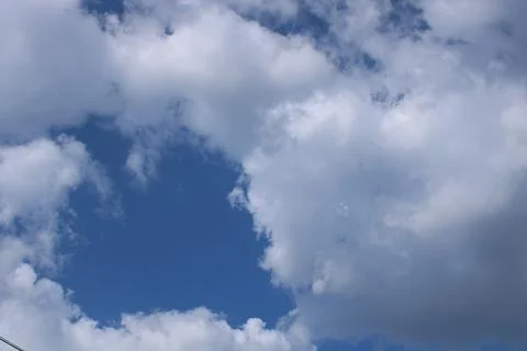 Clouds on a blue background with white clouds. Stock Photos