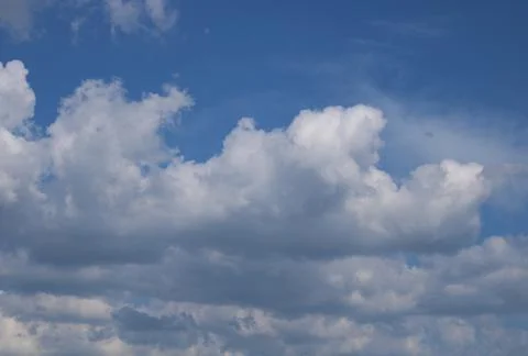 Clouds on a blue background with white clouds. Stock Photos