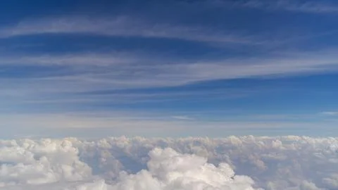 Clouds on a blue sky above and below the horizon Stock Photos