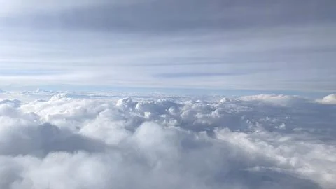 Clouds with blue sky from airplane window Stock Photos