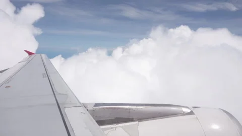 Clouds in the blue sky and wing of an aircraft Stock Footage 318525184