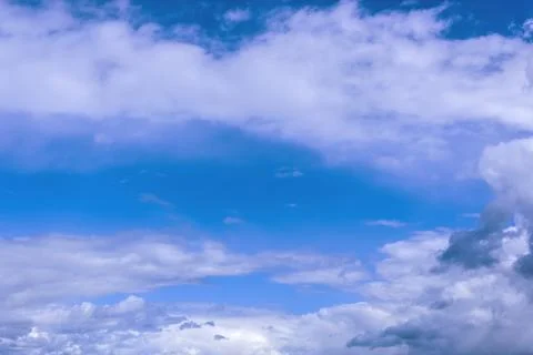 Clouds in the blue sky on a bright cloudy day Stock Photos