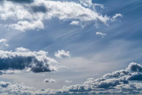 Clouds in the blue sky on a bright cloudy day Stock Photos