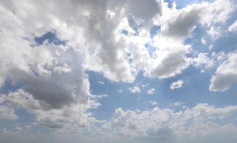 Clouds in the blue sky with divine light filtering through seemingly from h.. Stock-Fotos