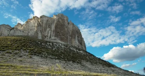 Clouds in the blue sky float on an old chalk mountain. Stock Footage 131114291