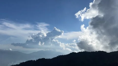 Clouds blue sky Green grassland and mountain natural landscape under the blue Stock Footage 323923733