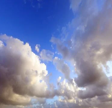 Clouds in the blue sky ideal as a background for the concept of paradise or.. Stock Photos