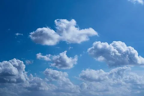 Clouds in the blue sky, light on the clouds in the sky Stock Photos