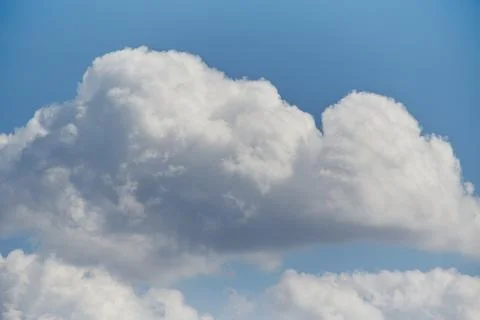 Clouds in the blue sky, light on the clouds in the sky Stock Photos