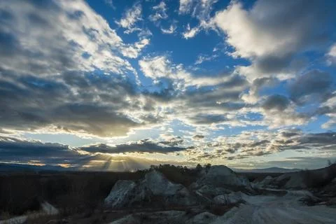 Clouds at the blue sky in a lime quarry during sundown in the spring Stock Photos