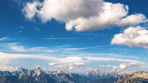 Clouds in blue sky over Alps mountains Stock Footage 293015475