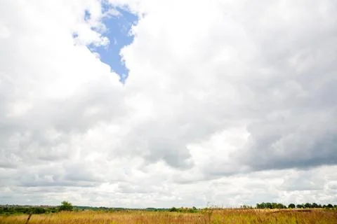 Clouds on blue sky over the field Stock Photos
