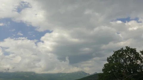 Clouds in blue sky over green mountains Video stock 79446278