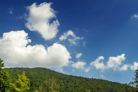 Clouds on blue sky over the hill - time lapse 2K Video stock 32370119