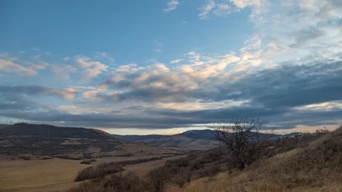 Clouds in blue sky over mountains, time lapse Stock Footage 121815964
